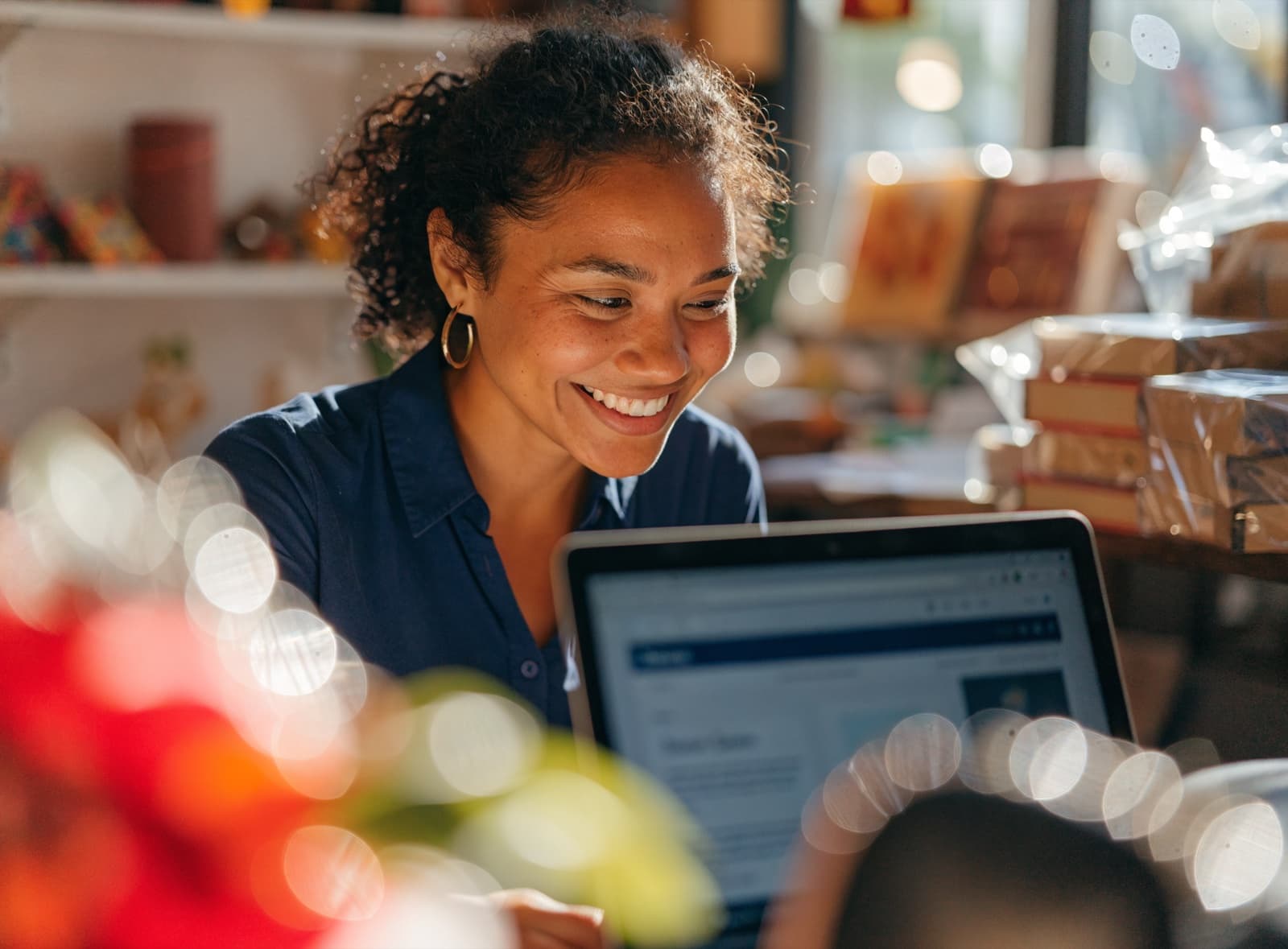 Small business owner smiling at her new online store